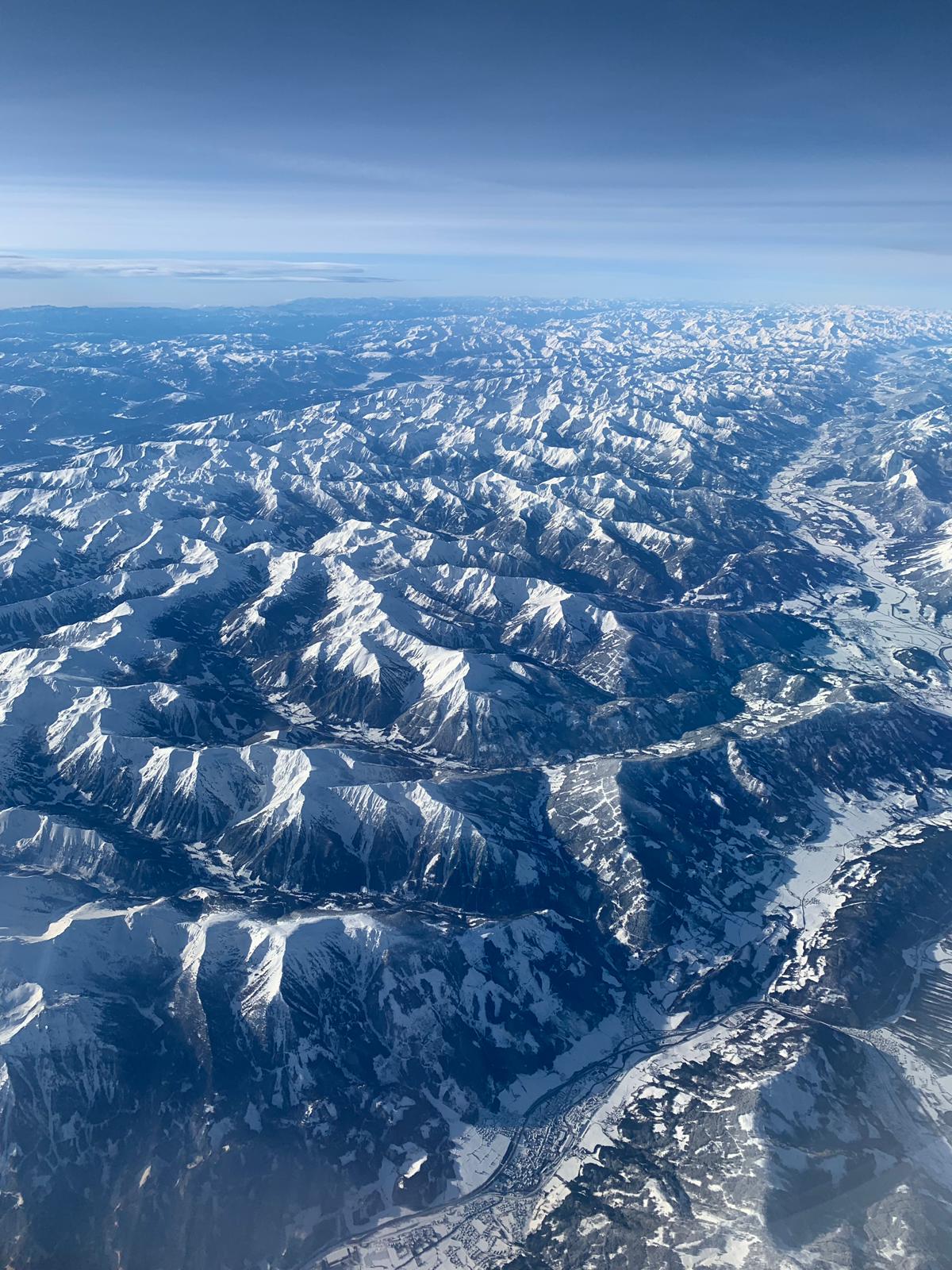 A broad snow-covered mountain range seen from above