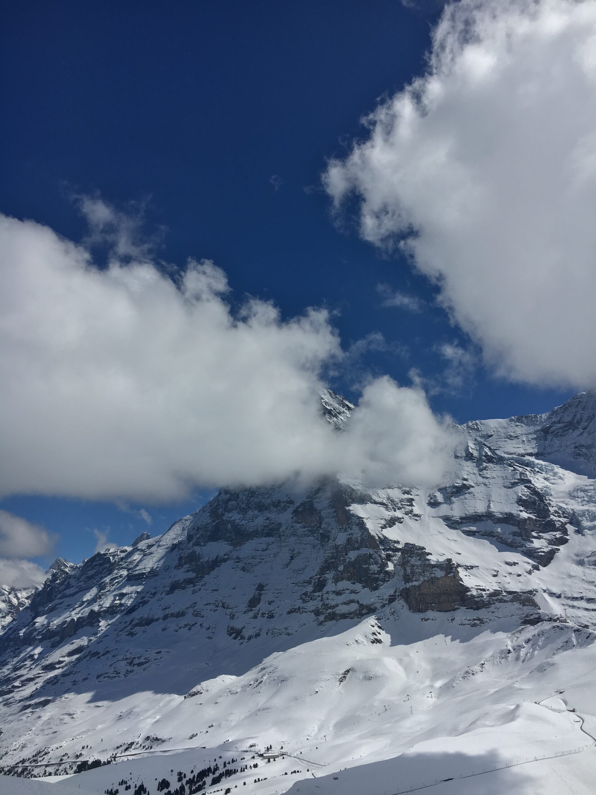 A wall of cloud rolling across mountain peaks