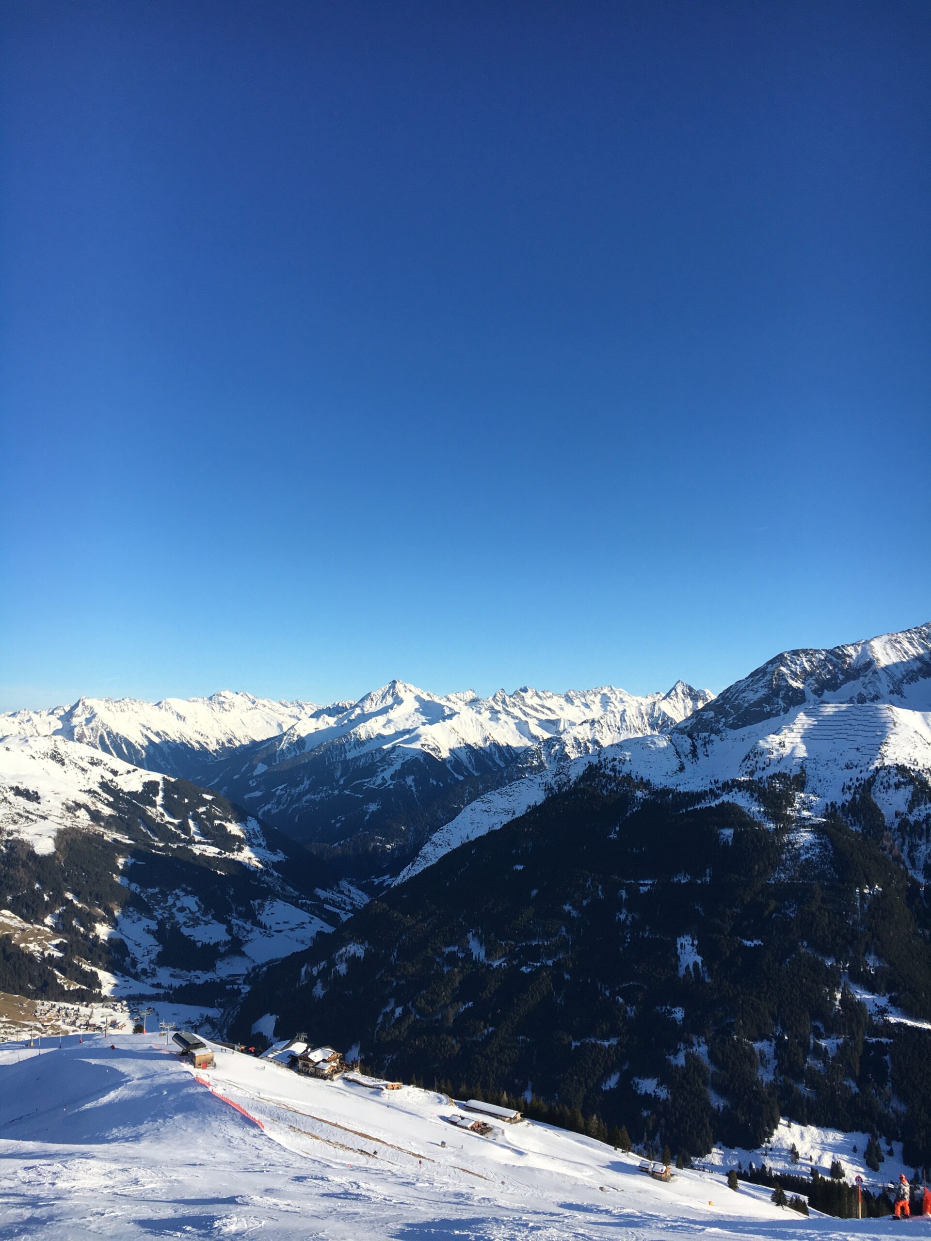 A vast snow-covered mountain panorama under a wide sky